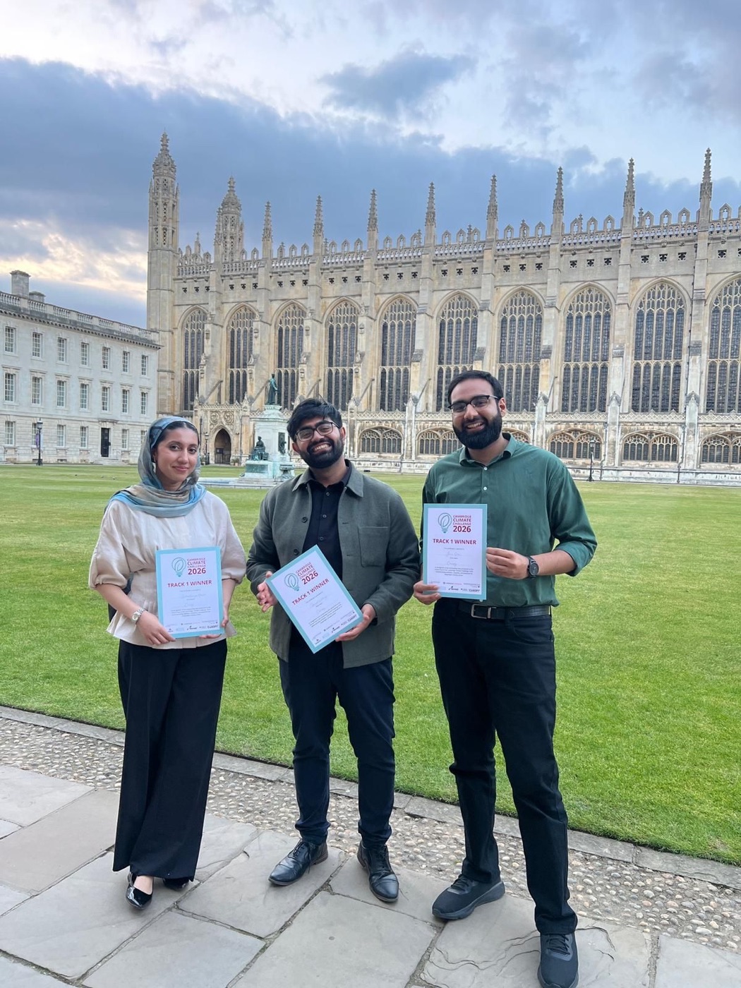 The three Canopy founders holding their Track 1 Winner certificates in front of King's College Chapel, Cambridge